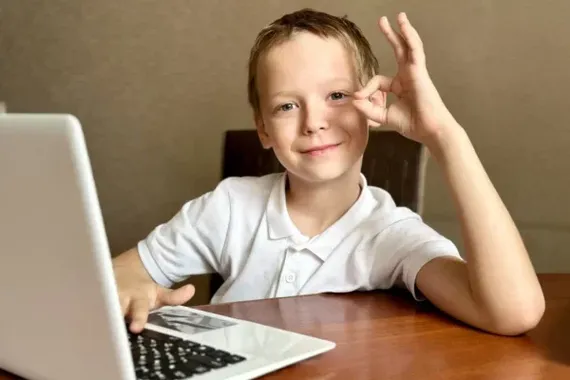 a boy in a white shirt with a white laptop 2023 11 27 05 06 20 utc e1770042888426