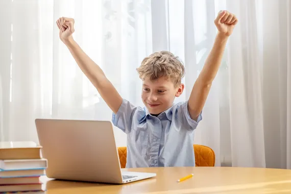 excited schoolboy learning online on laptop 2023 11 27 05 37 15 utc flipped