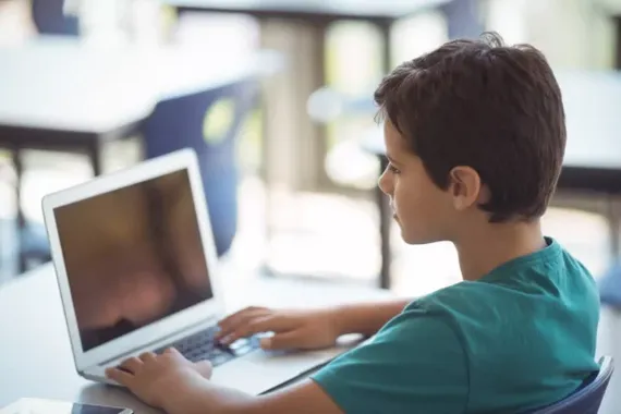 schoolboy using laptop in classroom 2023 11 27 05 36 18 utc scaled e1770043341435